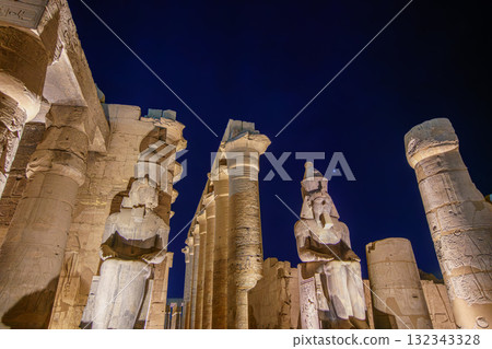 Night View of Giant Pharaoh Statues and Columns at Temple of Luxor Egypt. Night View of Giant Pharaoh Statues and Columns at Temple of Luxor Egypt. 132343328