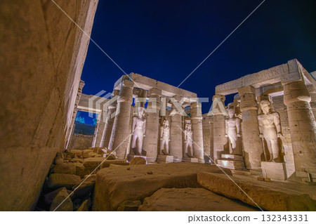 Illuminated Ancient Statues and Columns at Luxor Temple Egypt at Night. 132343331
