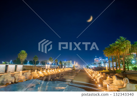 The Illuminated Avenue of Sphinxes and Ancient Columns Luxor Egypt at Night. The Illuminated Avenue of Sphinxes and Ancient Columns Luxor Egypt at Night. 132343340