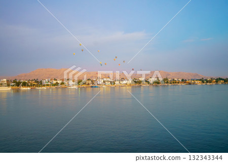 Hot air balloons over Luxor West Bank at sunrise from the Nile River. 132343344