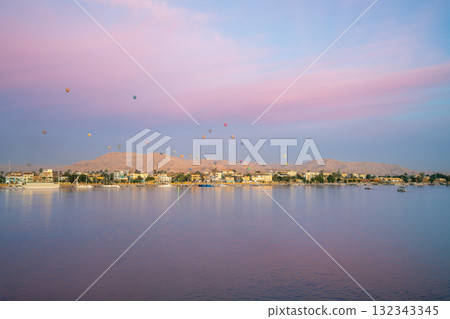 Hot Air Balloons Float Over West Bank of Luxor Egypt at Dawn from Nile Cruise. 132343345