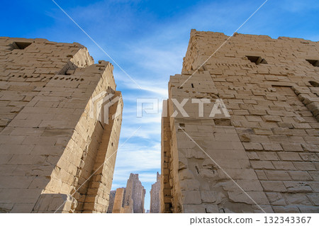Massive Stone Pylons at Karnak Temple Luxor Egypt Against Blue Sky. Massive Stone Pylons at Karnak Temple Luxor Egypt Against Blue Sky. 132343367