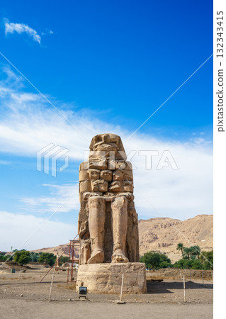Colossi of Memnon Ancient Pharaoh Statues in Luxor Egypt Blue Sky. 132343415