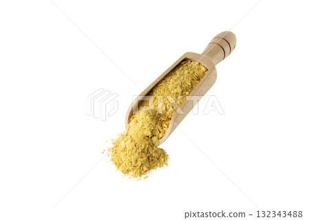 Savoury vegan yeast flakes in wooden scoop isolated on white background. Savoury vegan yeast flakes in wooden scoop isolated on white background. 132343488