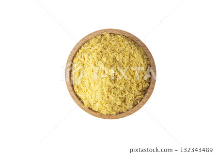 Savoury vegan yeast flakes in wooden bowl isolated on white background. 132343489