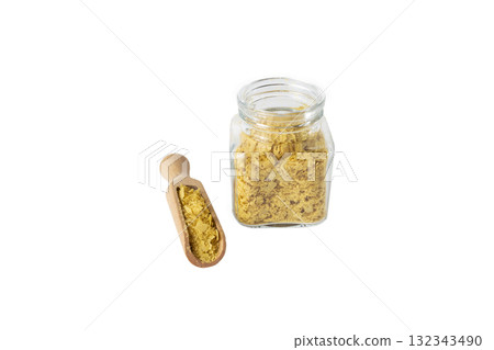 Savoury vegan yeast flakes in wooden scoop and glass jar isolated on white background. 132343490