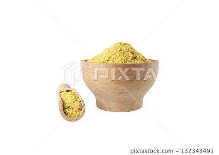 Savoury vegan yeast flakes in wooden bowl and scoop isolated on white background. 132343491