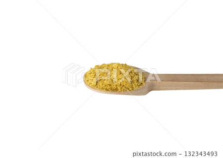 Savoury vegan yeast flakes on wooden spoon isolated on white background. Savoury vegan yeast flakes on wooden spoon isolated on white background. 132343493