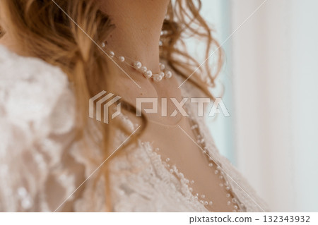 Elegant Bride Adorns Pearl Necklace. Wedding Day Close-Up. Soft Focus. Romantic Lace. Cream and White Tones. Feminine Beauty Portrait. 132343932
