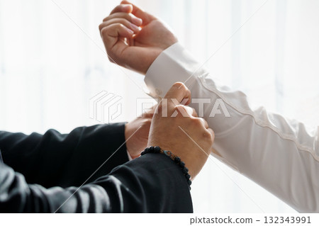 Business Negotiation Handshake Agreement Dark Suit, White Shirt, Black Bracelet, Formal Attire, Close-Up, Successful Deal, Trust, Partnership. Business Negotiation Handshake Agreement Dark Suit, White Shirt, Black Bracelet, Formal Attire, Close-Up, Successful Deal, Trust, Partnership. 132343991