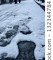 Bicycle and shoe prints on frozen asphalt 132344784