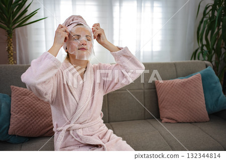 Young Woman Applying Cosmetic Face Mask at Home 132344814