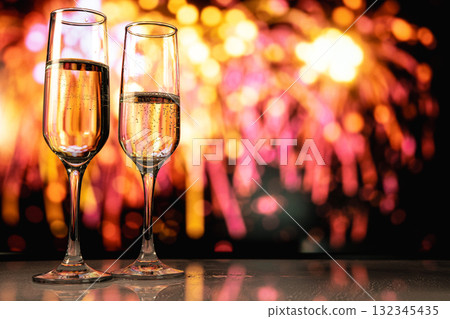 Romantic couple toasting champagne amidst fireworks reflected on terrace during New Year midnight 132345435