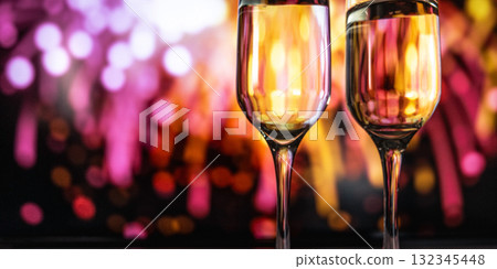 Elegant romantic celebration, Stylish evening with glowing glasses and celebratory fireworks Elegant romantic celebration, Stylish evening with glowing glasses and celebratory fireworks 132345448