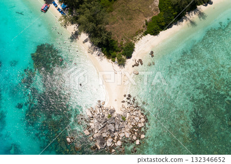 Breathtaking view of a secluded beach with crystal clear waters and rocky formations on the Perhentian islands. Malaysia 132346652