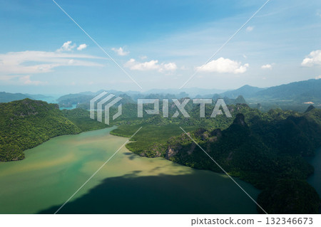 Top view of the green mountains and river in KILIM Geopark on a sunny day with a clear sky. Langkawi. Malaysia Top view of the green mountains and river in KILIM Geopark on a sunny day with a clear sky. Langkawi. Malaysia 132346673