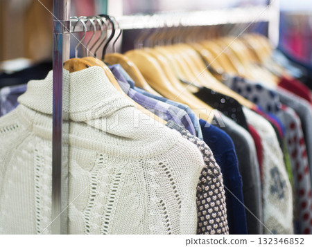 Fashionable clothes on hangers in a store Fashionable clothes on hangers in a store 132346852