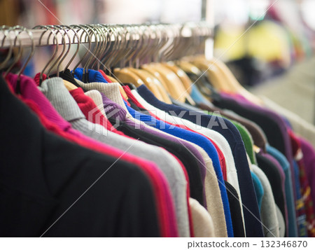 Fashionable clothes on hangers in a store 132346870