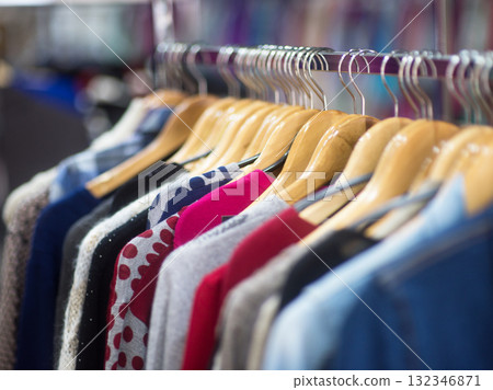 Fashionable clothes on hangers in a store 132346871
