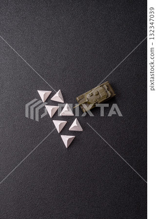 Anti-tank barrier or dragon's teeth made of concrete and iron as a fortification. Dragon's teeth Anti-tank barrier or dragon's teeth made of concrete and iron as a fortification. Dragon's teeth 132347039