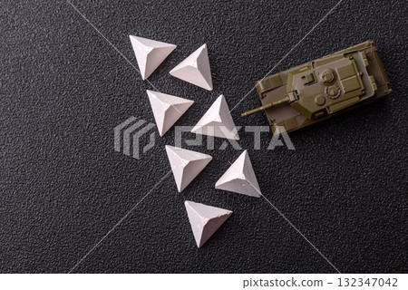 Anti-tank barrier or dragon's teeth made of concrete and iron as a fortification. Dragon's teeth Anti-tank barrier or dragon's teeth made of concrete and iron as a fortification. Dragon's teeth 132347042