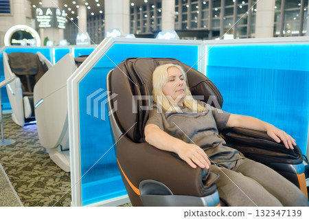 Comfortable relaxation experience at a modern wellness center during a sunny day while enjoying a massage chair Comfortable relaxation experience at a modern wellness center during a sunny day while enjoying a massage chair 132347139