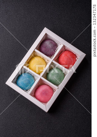 Japanese mochi, ice cream or Asian sweets with fruit filling. Mochi of different colors Japanese mochi, ice cream or Asian sweets with fruit filling. Mochi of different colors 132347178