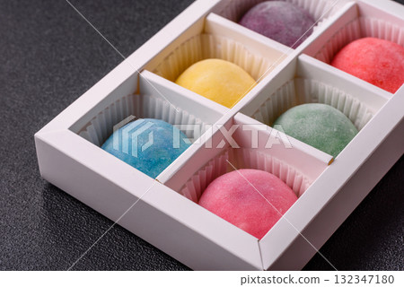 Japanese mochi, ice cream or Asian sweets with fruit filling. Mochi of different colors Japanese mochi, ice cream or Asian sweets with fruit filling. Mochi of different colors 132347180