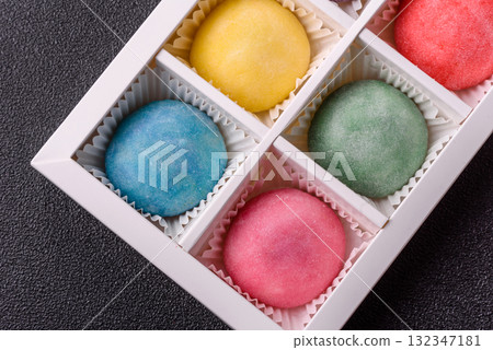 Japanese mochi, ice cream or Asian sweets with fruit filling. Mochi of different colors 132347181
