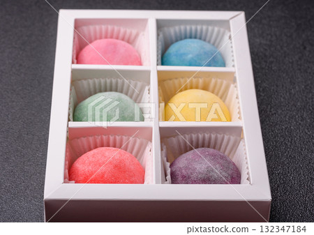 Japanese mochi, ice cream or Asian sweets with fruit filling. Mochi of different colors Japanese mochi, ice cream or Asian sweets with fruit filling. Mochi of different colors 132347184