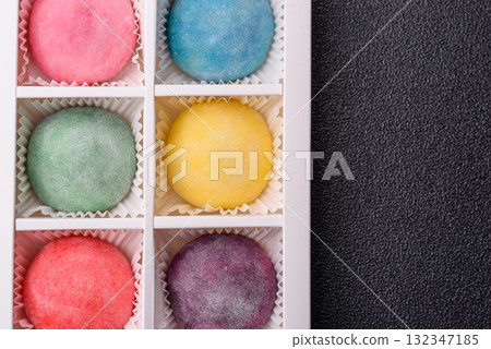 Japanese mochi, ice cream or Asian sweets with fruit filling. Mochi of different colors Japanese mochi, ice cream or Asian sweets with fruit filling. Mochi of different colors 132347185