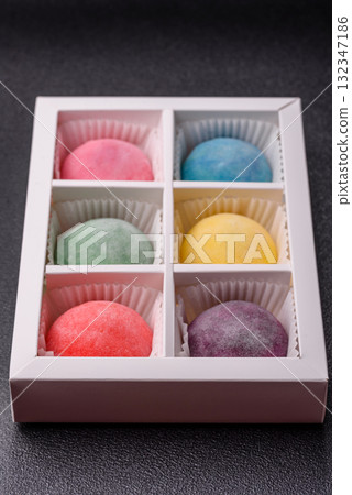 Japanese mochi, ice cream or Asian sweets with fruit filling. Mochi of different colors 132347186