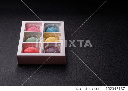 Japanese mochi, ice cream or Asian sweets with fruit filling. Mochi of different colors Japanese mochi, ice cream or Asian sweets with fruit filling. Mochi of different colors 132347187