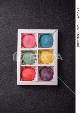 Japanese mochi, ice cream or Asian sweets with fruit filling. Mochi of different colors Japanese mochi, ice cream or Asian sweets with fruit filling. Mochi of different colors 132347189