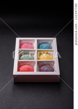 Japanese mochi, ice cream or Asian sweets with fruit filling. Mochi of different colors Japanese mochi, ice cream or Asian sweets with fruit filling. Mochi of different colors 132347190