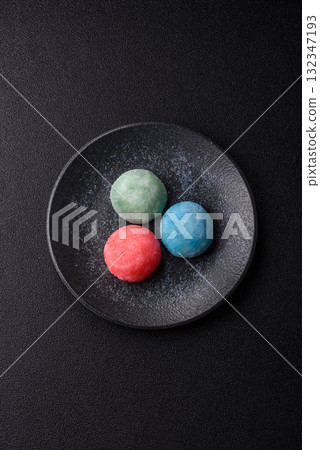 Japanese mochi, ice cream or Asian sweets with fruit filling. Mochi of different colors 132347193