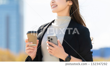 A woman/businesswoman gazing into the distance 132347292