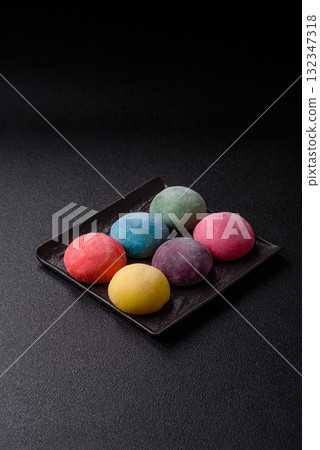 Japanese mochi, ice cream or Asian sweets with fruit filling. Mochi of different colors Japanese mochi, ice cream or Asian sweets with fruit filling. Mochi of different colors 132347318