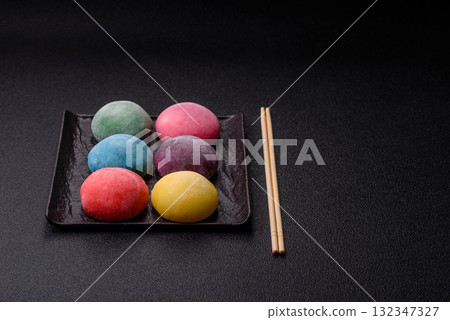 Japanese mochi, ice cream or Asian sweets with fruit filling. Mochi of different colors 132347327