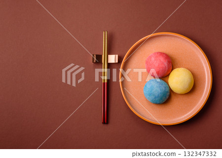 Japanese mochi, ice cream or Asian sweets with fruit filling. Mochi of different colors 132347332