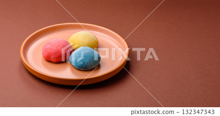 Japanese mochi, ice cream or Asian sweets with fruit filling. Mochi of different colors 132347343