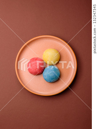Japanese mochi, ice cream or Asian sweets with fruit filling. Mochi of different colors Japanese mochi, ice cream or Asian sweets with fruit filling. Mochi of different colors 132347345