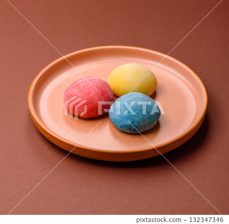 Japanese mochi, ice cream or Asian sweets with fruit filling. Mochi of different colors 132347346