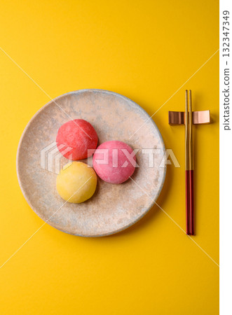 Japanese mochi, ice cream or Asian sweets with fruit filling. Mochi of different colors Japanese mochi, ice cream or Asian sweets with fruit filling. Mochi of different colors 132347349