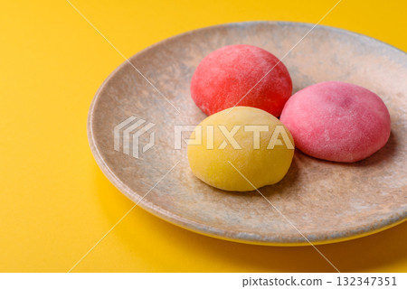Japanese mochi, ice cream or Asian sweets with fruit filling. Mochi of different colors Japanese mochi, ice cream or Asian sweets with fruit filling. Mochi of different colors 132347351