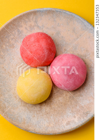 Japanese mochi, ice cream or Asian sweets with fruit filling. Mochi of different colors Japanese mochi, ice cream or Asian sweets with fruit filling. Mochi of different colors 132347353