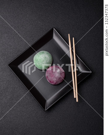 Japanese mochi, ice cream or Asian sweets with fruit filling. Mochi of different colors 132347378