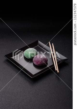Japanese mochi, ice cream or Asian sweets with fruit filling. Mochi of different colors Japanese mochi, ice cream or Asian sweets with fruit filling. Mochi of different colors 132347379
