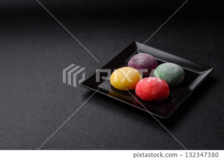 Japanese mochi, ice cream or Asian sweets with fruit filling. Mochi of different colors Japanese mochi, ice cream or Asian sweets with fruit filling. Mochi of different colors 132347380