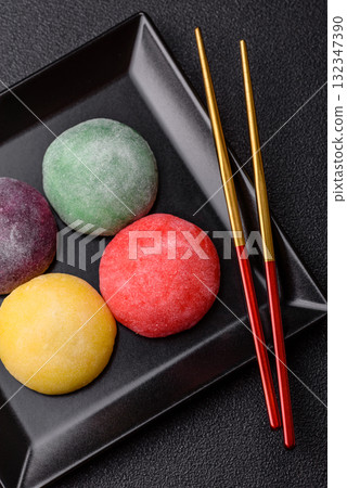 Japanese mochi, ice cream or Asian sweets with fruit filling. Mochi of different colors 132347390